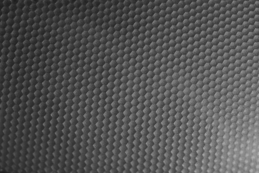 A Black And White Photo Of A Metal Surface Wallpaper