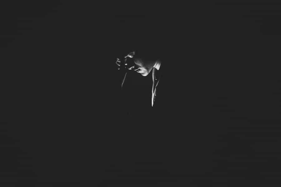 A Black And White Photo Of A Person In The Dark Wallpaper