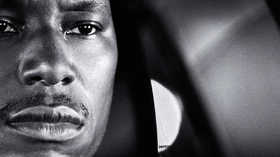 A Black Man Is Staring Out Of A Car Window Wallpaper