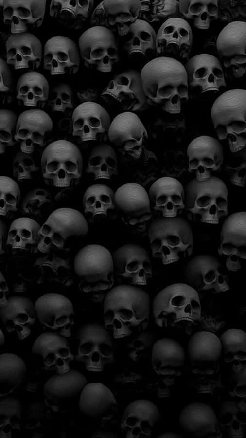 A Black Skull Wall With Many Skulls In It Wallpaper
