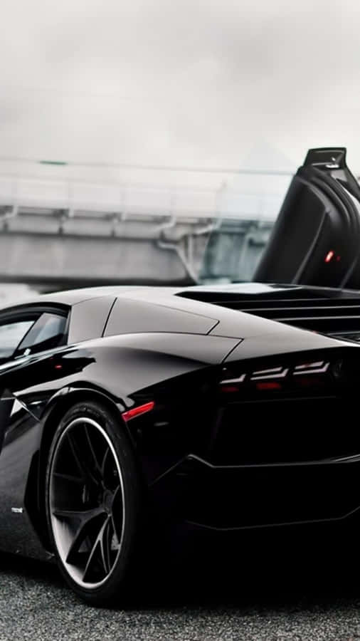 A Black Sports Car With Its Doors Open Wallpaper
