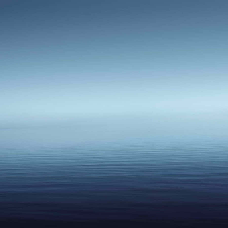 A Blue Sky With A Calm Ocean Wallpaper