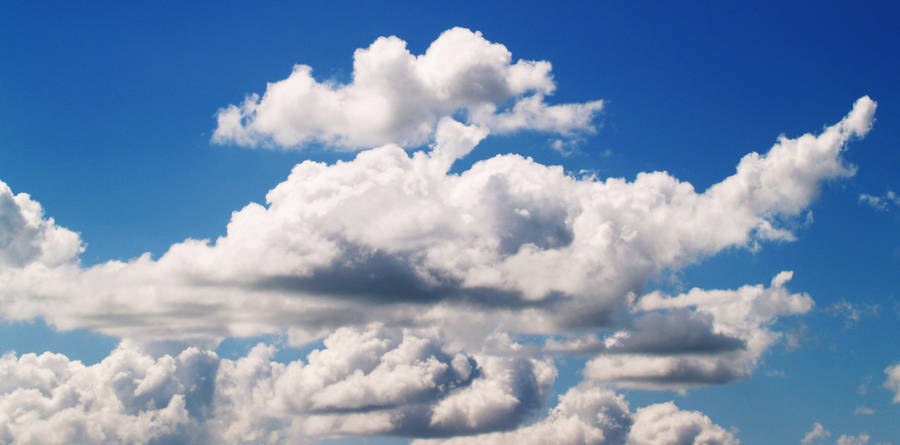 A Blue Sky With White Clouds Wallpaper