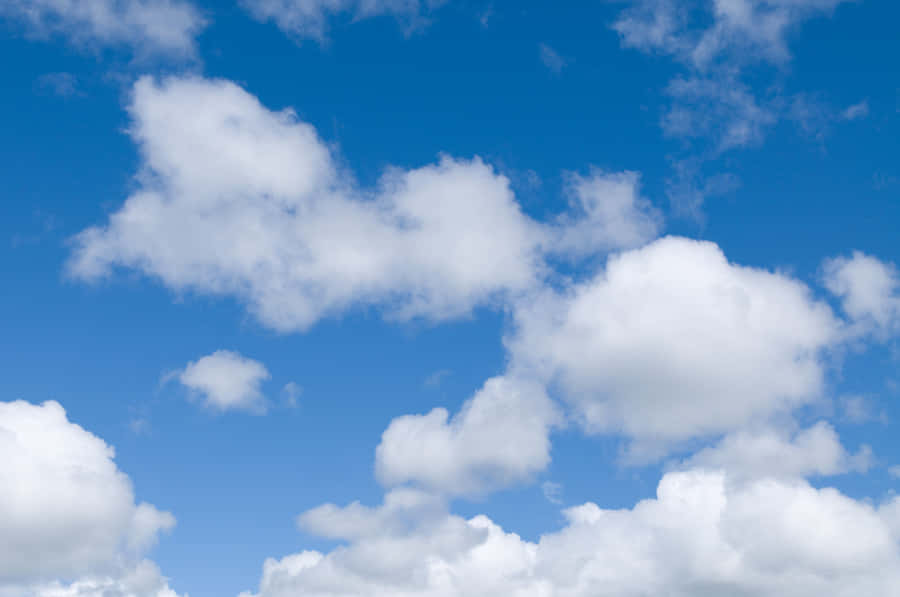 A Blue Sky With White Clouds Wallpaper