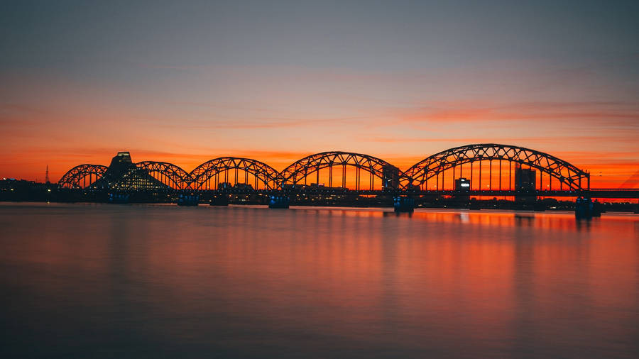 A Breathtaking Sunset At Riga's Railway Beach Wallpaper