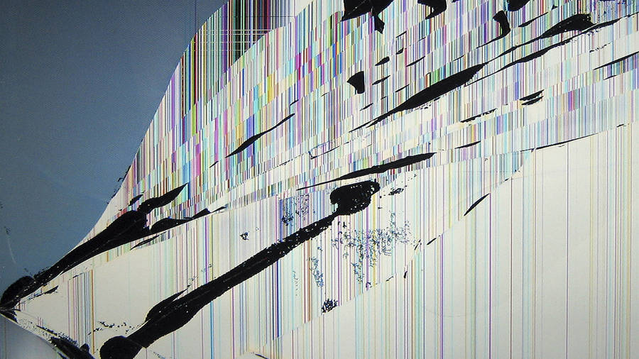 A Broken Computer Screen Looks Out At A Blurred Office. Wallpaper