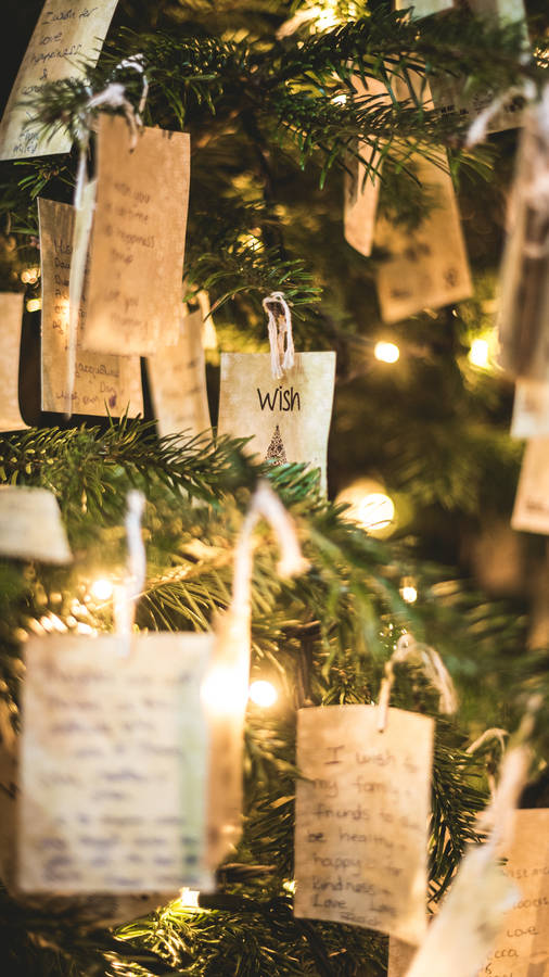 A Cheerful Display Of Holiday Cards On A Colourful Christmas Tree Wallpaper