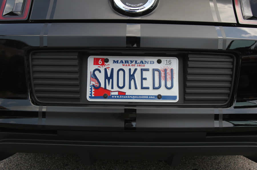 A Close-up View Of A Vintage Car's License Plate Wallpaper