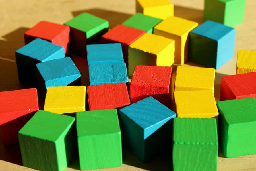 A Colorfully Assorted Collection Of Educational Toys On A White Surface Wallpaper