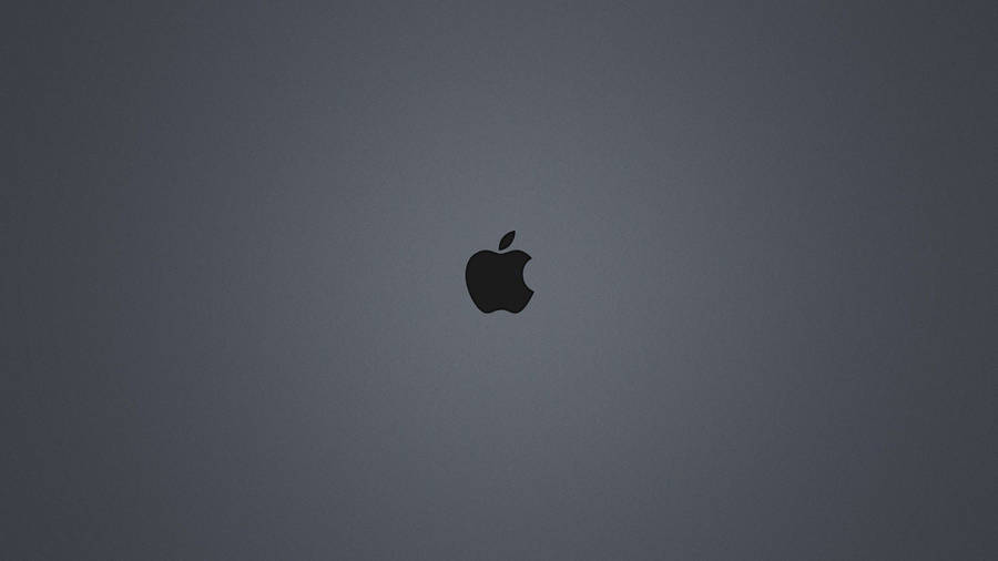 A Dark-gray Background Illuminated By The Iconic Black Apple Logo Wallpaper