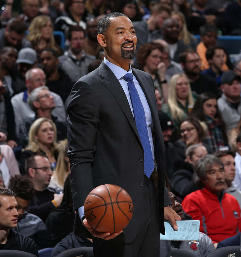 A Dedicated Basketball Coach Training His Team On The Court Wallpaper