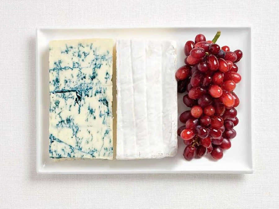 A Delicious Slice Of Blue Cheese, Perfect For Adding Flavor To Any Dish. Wallpaper