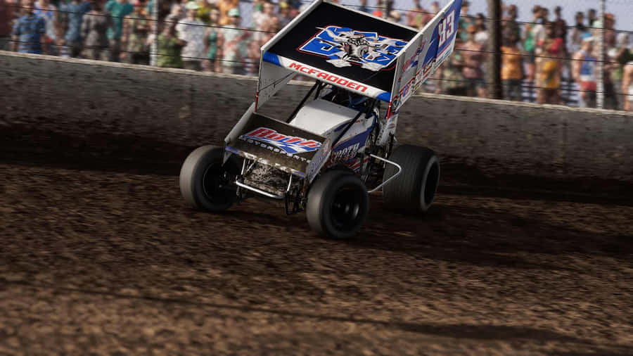 A Dirt Track Racer Driving In Front Of A Crowd Wallpaper