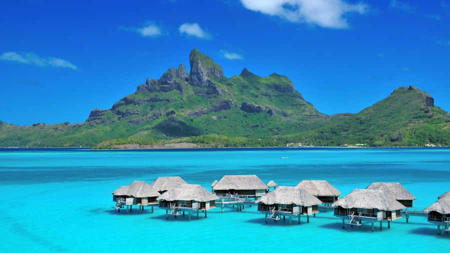 A Dreamy Sunrise In Bora Bora Wallpaper