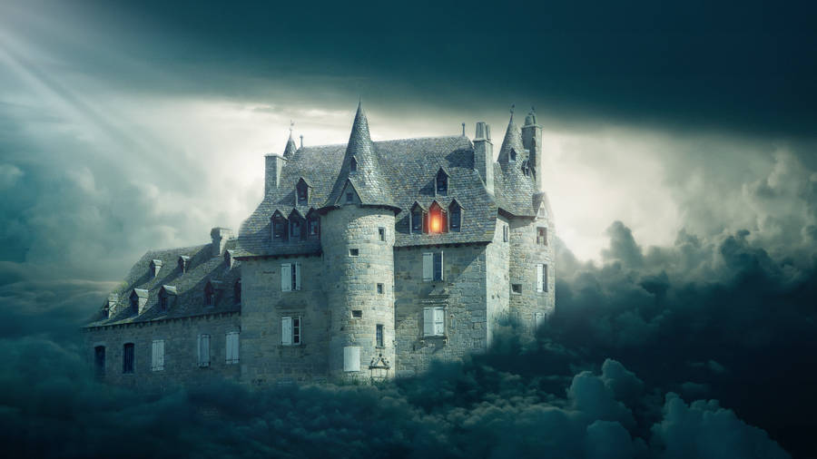 A Gloomy And Mystical Castle Surrounded By Clouds Wallpaper