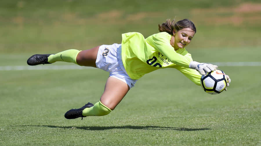 A Goalkeeper Poised For Action During A Soccer Match Wallpaper