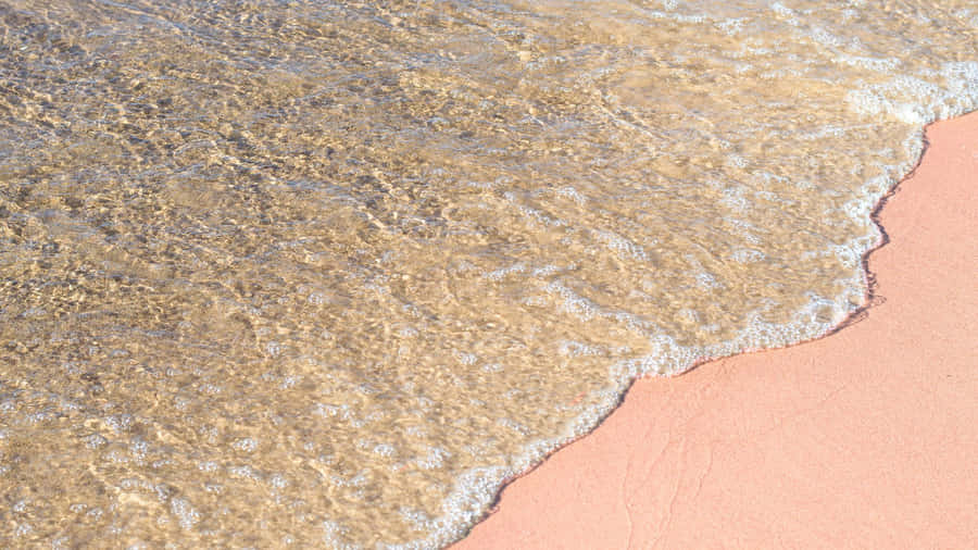 A Hidden Paradise: Breathtaking View Of The Stunning Pink Beach Wallpaper