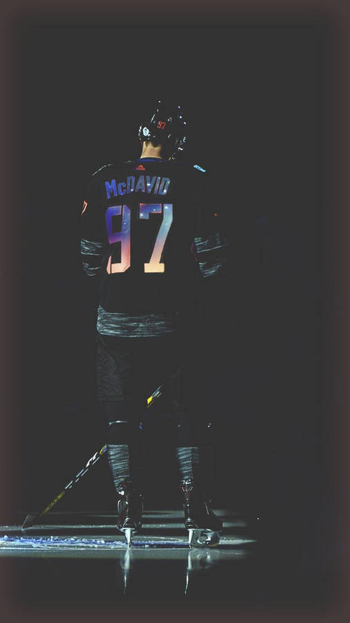 A Hockey Player Is Standing On The Ice Wallpaper