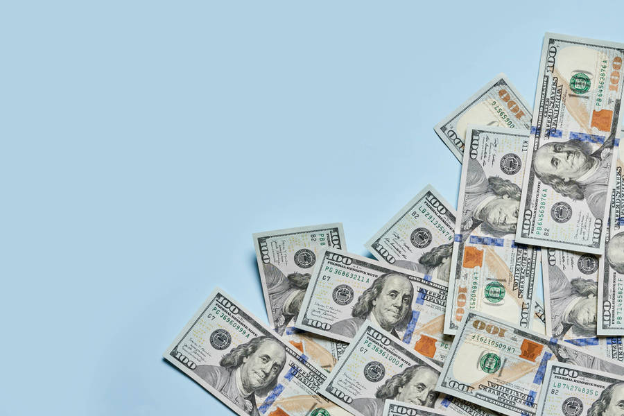 A Hundred-dollar Bill With Vibrant Blue Hues Wallpaper
