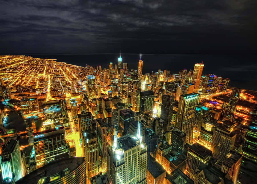 A Majestic City Skyline Reflecting On The Water At Sunset Wallpaper