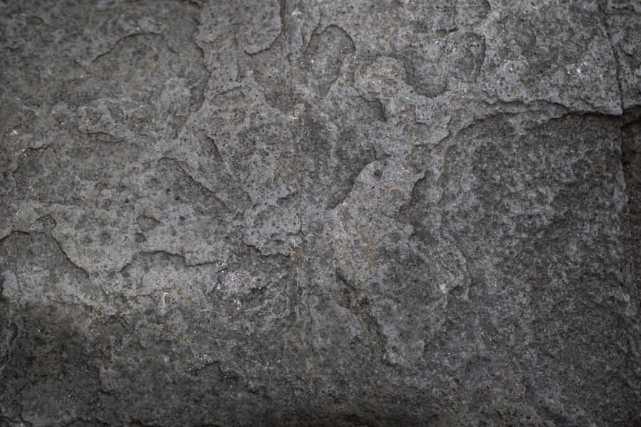 A Majestic Dark Rock On A Misty Mountain Path Wallpaper