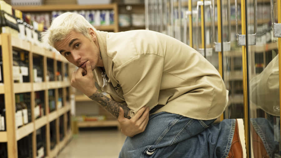 A Man In A Store With Bottles Of Wine Wallpaper