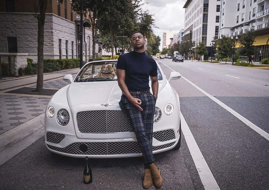 A Man Is Leaning On A Bentley Continental Wallpaper