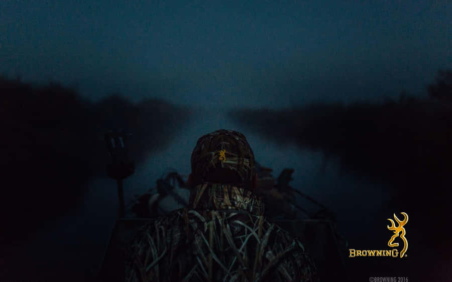 A Man Is Sitting In A Boat At Night Wallpaper