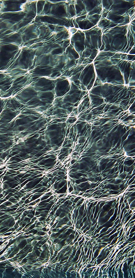 A Man Is Swimming In A Pool Wallpaper