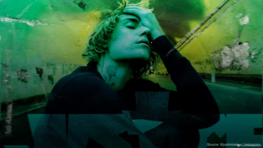 A Man With Green Hair Is Holding His Head Up Wallpaper