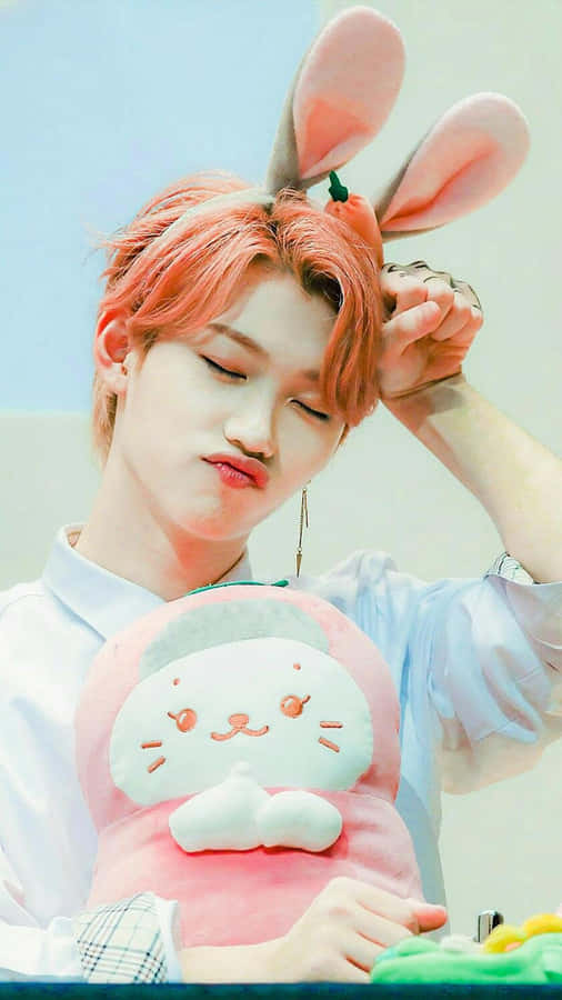 A Man With Pink Hair Holding A Pink Bunny Stuffed Animal Wallpaper