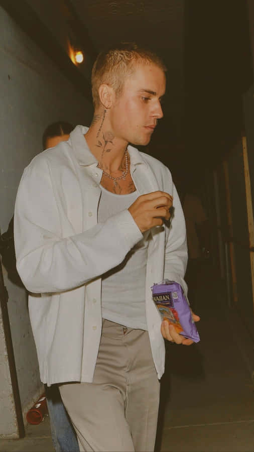 A Man With Tattoos Walking Down The Street Wallpaper