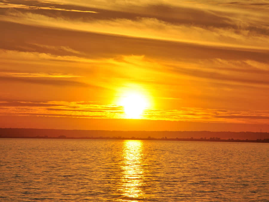 A Mesmerizing Yellow Sunset Over A Beautiful Landscape Wallpaper