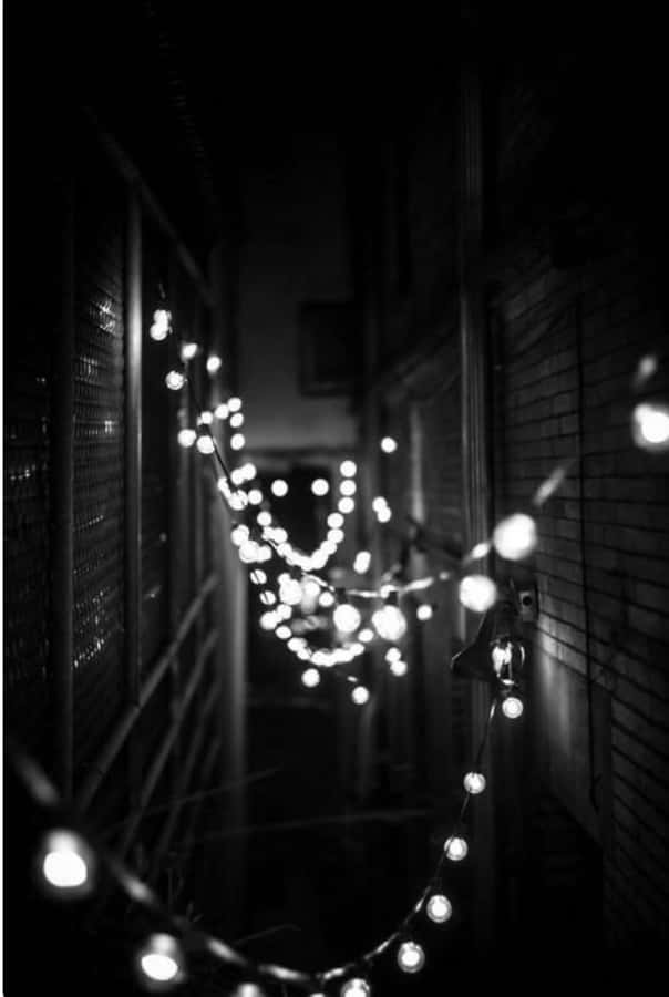 A Minimalist Aesthetic Of A White Iphone With Black Accents Wallpaper