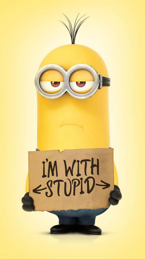 A Minion Holding A Sign That Says I'm With Stupid Wallpaper