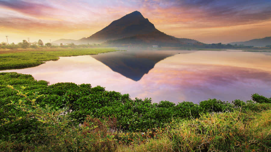 A Mountain Is Reflected In The Water Wallpaper