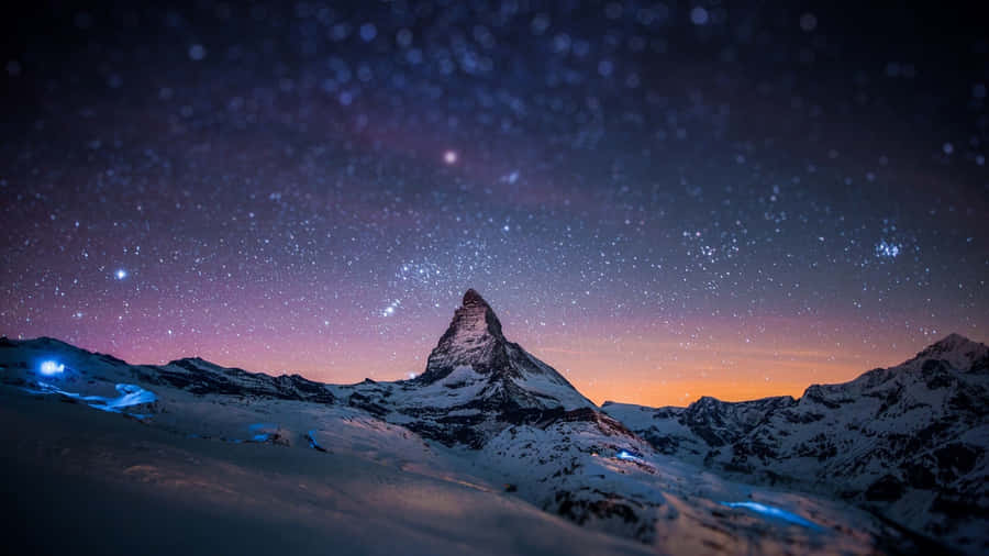 A Mountain With Stars And A Mountain Peak Wallpaper