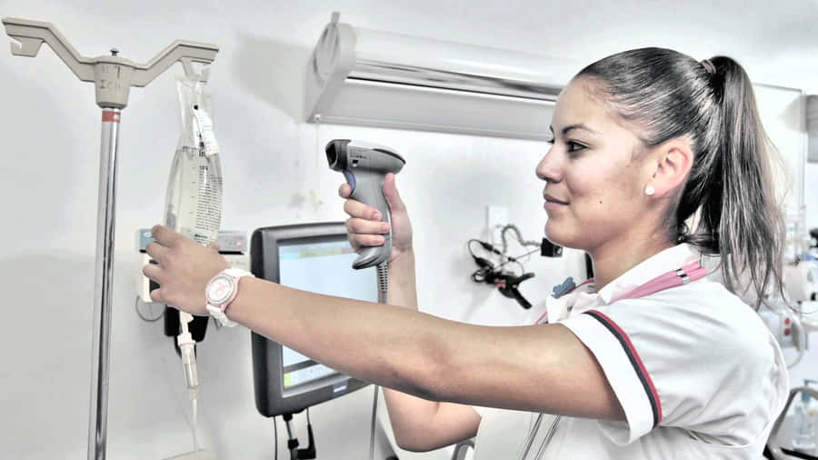 A Nurse Is Using A Device To Check A Patient Wallpaper