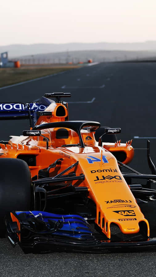 A Orange And Blue Racing Car On A Track Wallpaper