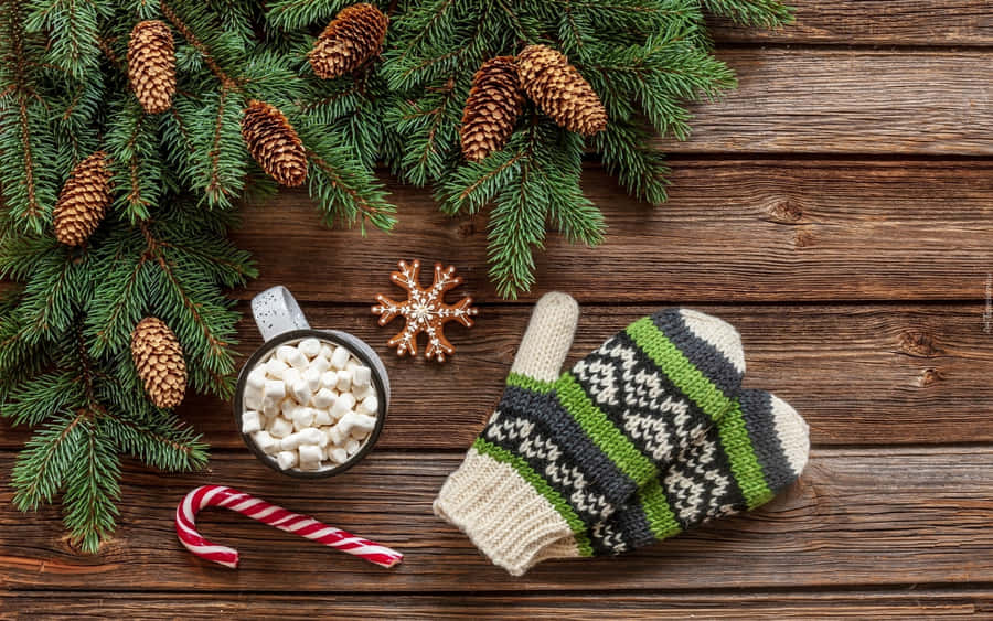 A Pair Of Cozy Wool Mittens On A Wooden Surface Wallpaper