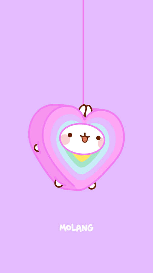 A Pink Heart Hanging From A String Wallpaper