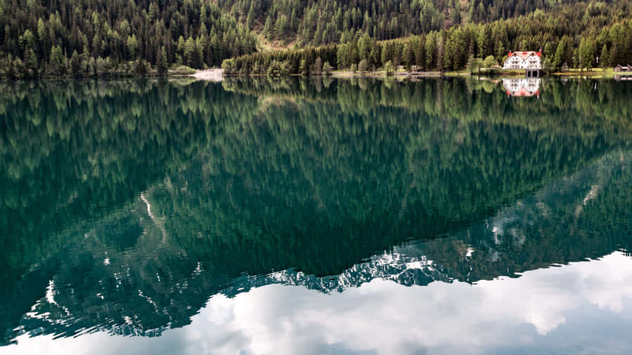 A Placid Lake In Antholzer See Wallpaper