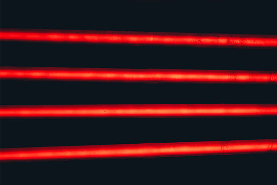A Red Line Cascades Through The Night Sky Wallpaper