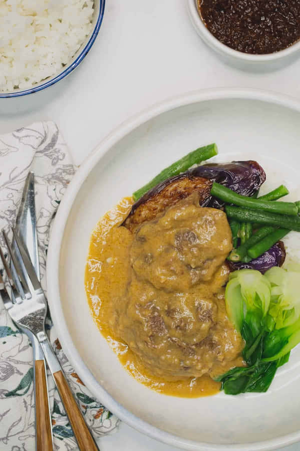 A Savory Bowl Of Kare-kare, A Traditional Filipino Delicacy. Wallpaper