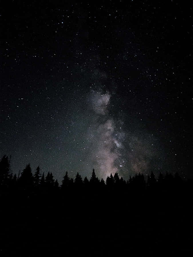 A Serene Night Sky Illuminated By A Full Moon. Wallpaper