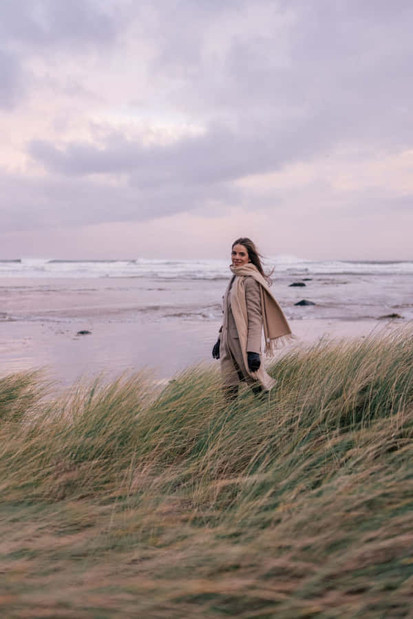 A Serene Winter Beach With A Snowy Shoreline Wallpaper