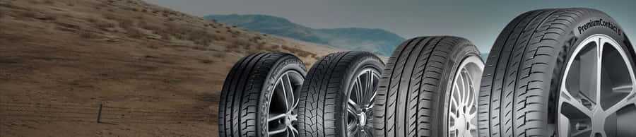 A Set Of Brand New Winter Tires Mounted On Modern Car Wheels Wallpaper