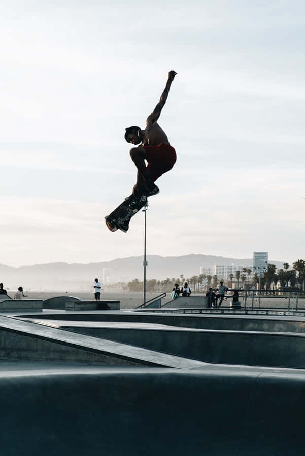 A Skateboarder Performing A Grind On A Rail Wallpaper
