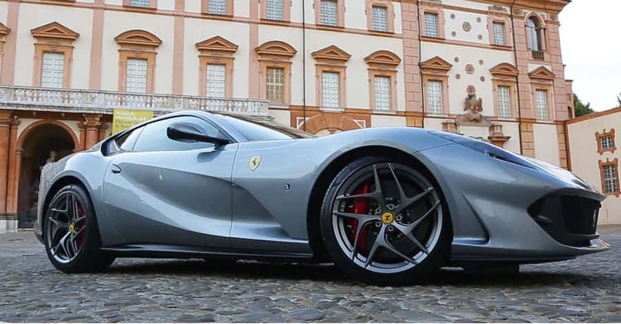 A Sleek Red Ferrari 812 Superfast In Action Wallpaper