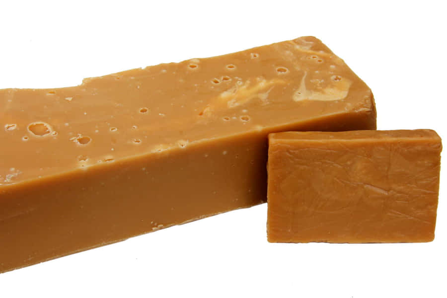 A Slice Of Delectable Penuche Fudge On A Rustic Wooden Table Wallpaper